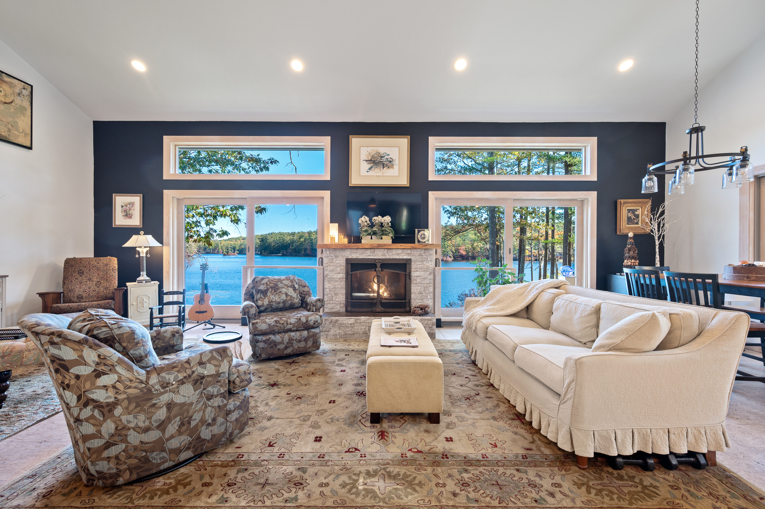 Elegant living room with large windows overlooking a lush garden.