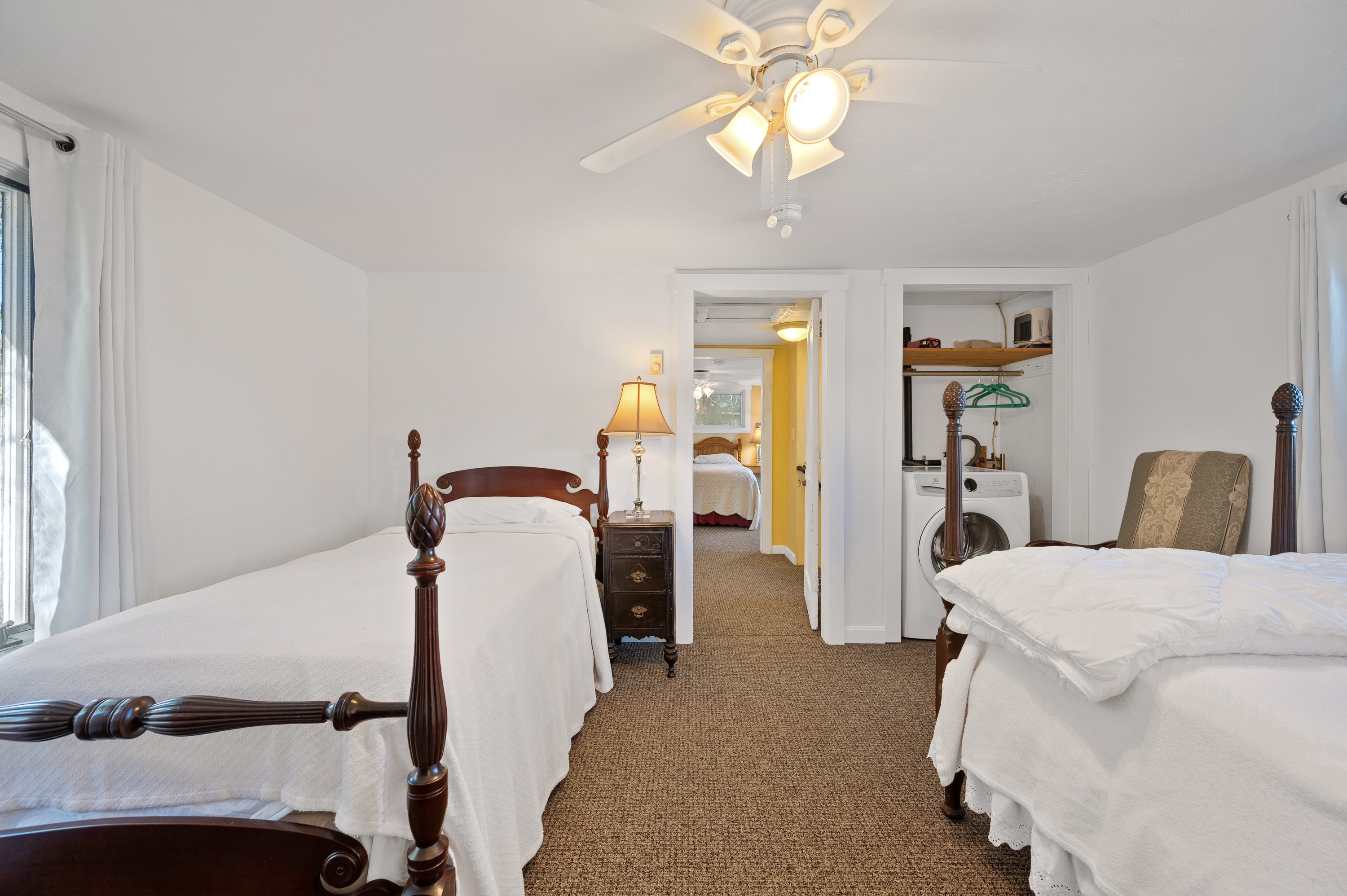 Cozy bedroom with twin beds and warm lighting.