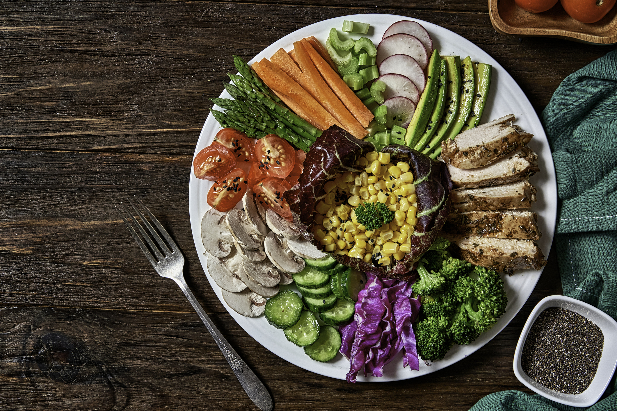 A colorful, healthy salad bowl with various fresh vegetables and greens.