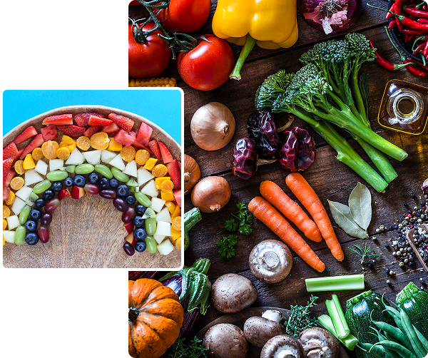Colorful rainbow made from sliced fruits and vegetables on a plate.