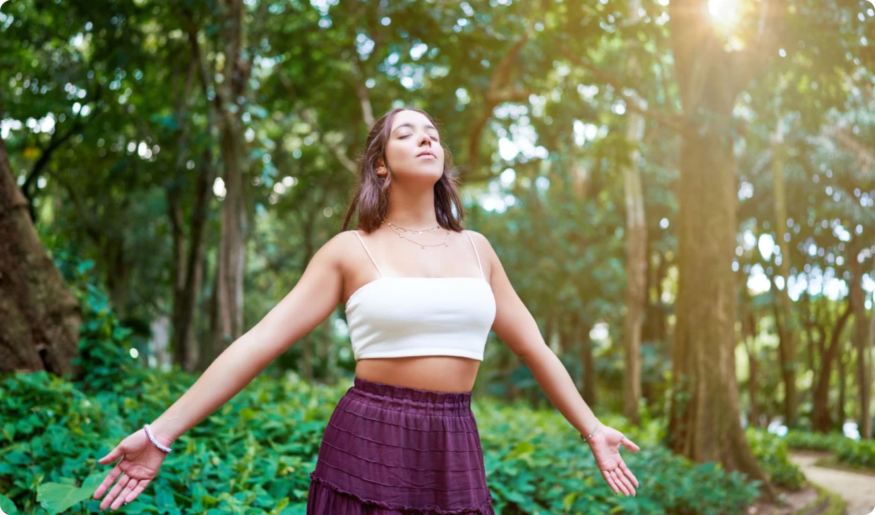 Woman enjoying nature with open arms