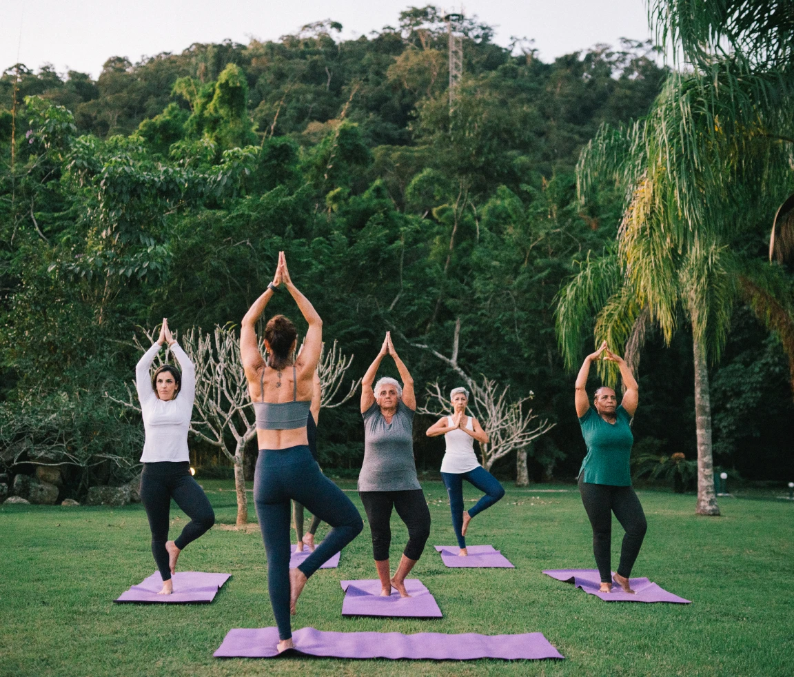 Outdoor yoga class with five participants